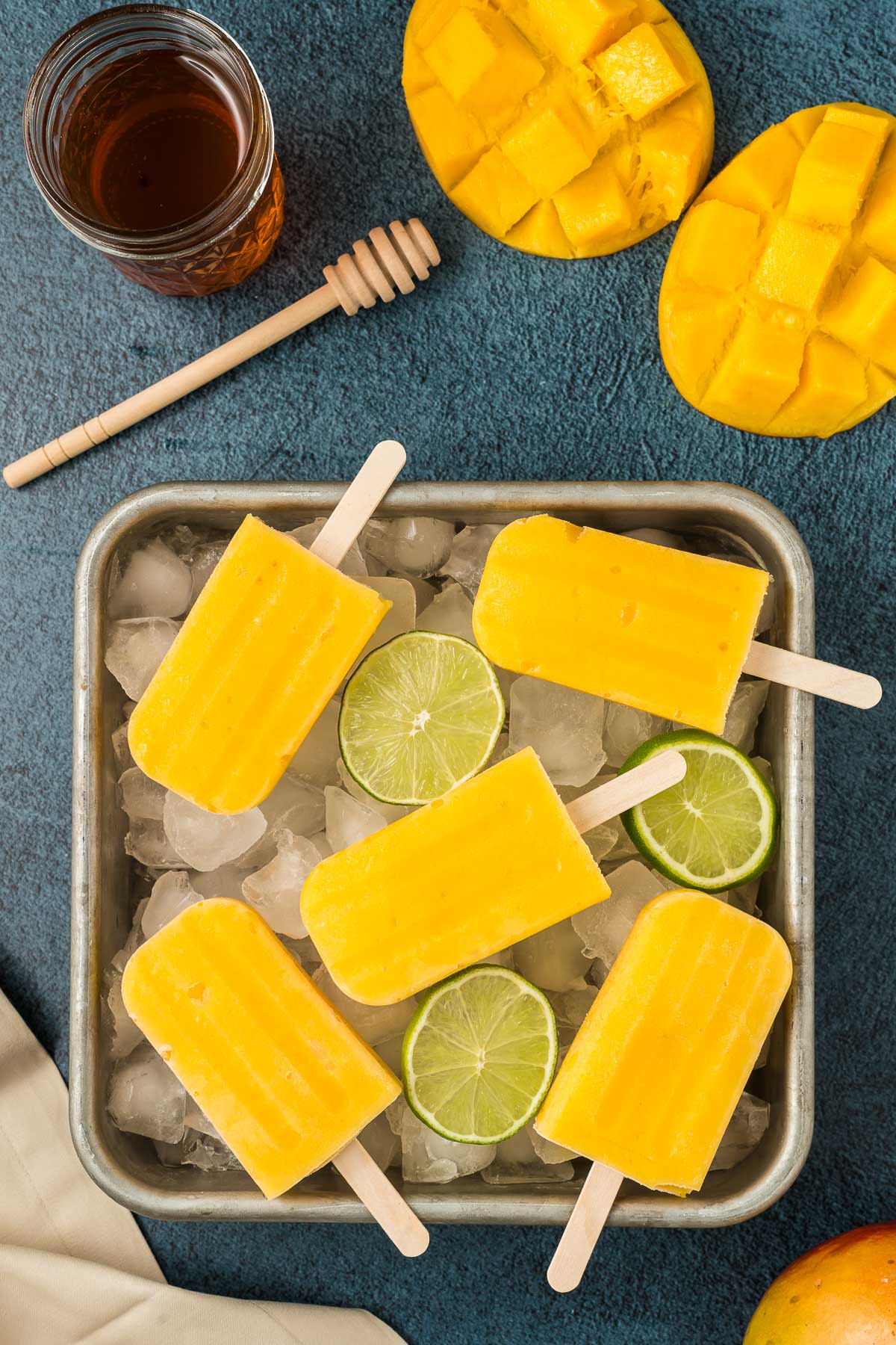 Tray of mango popsicles in ice