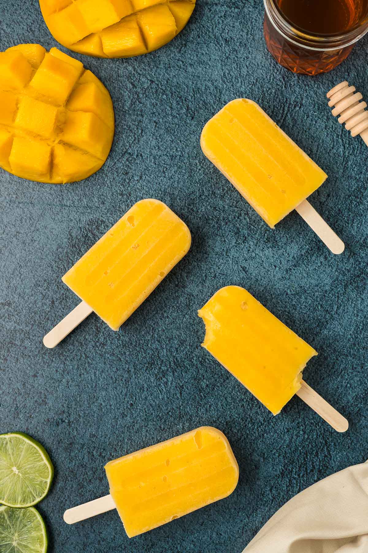 Mango popsicles on dark background