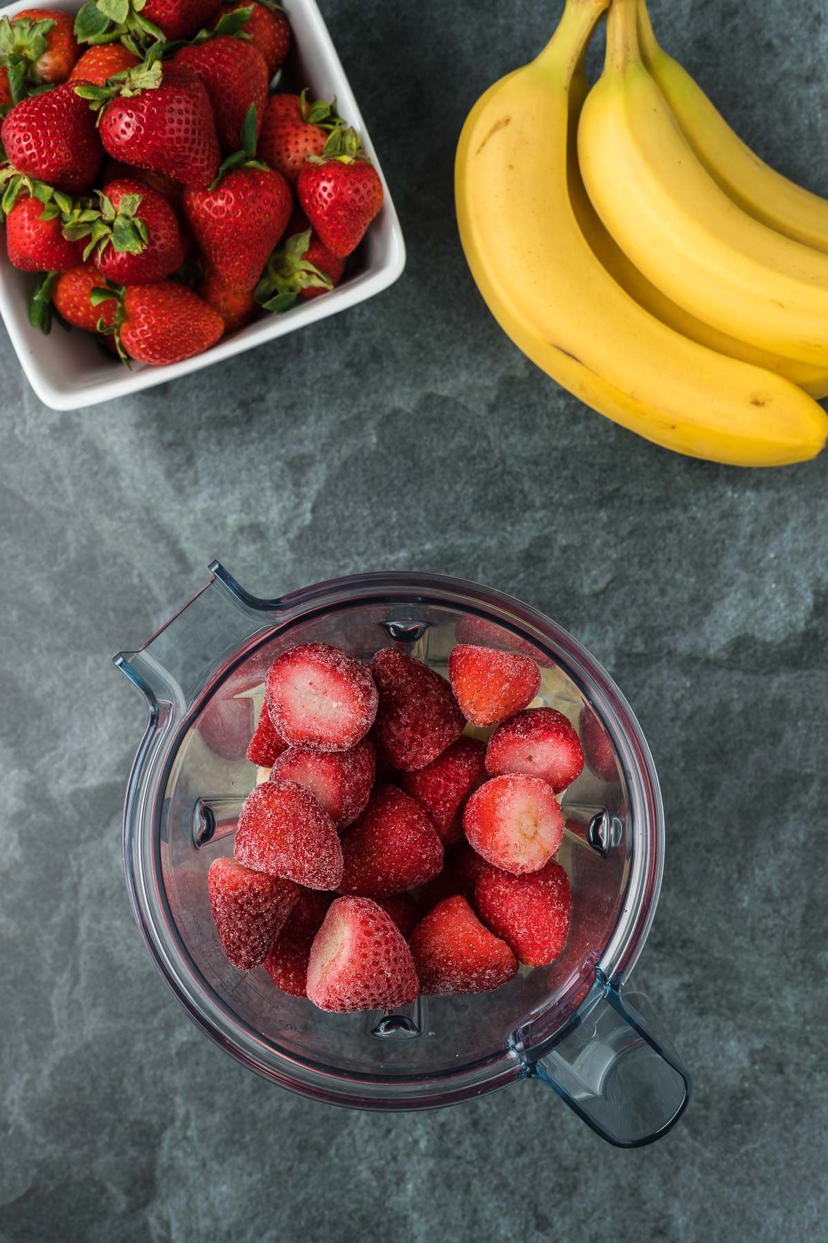 Strawberries in a blender with whole bananas