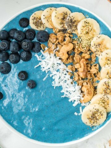 Blue superfood smoothie bowl with banana and blueberry topping