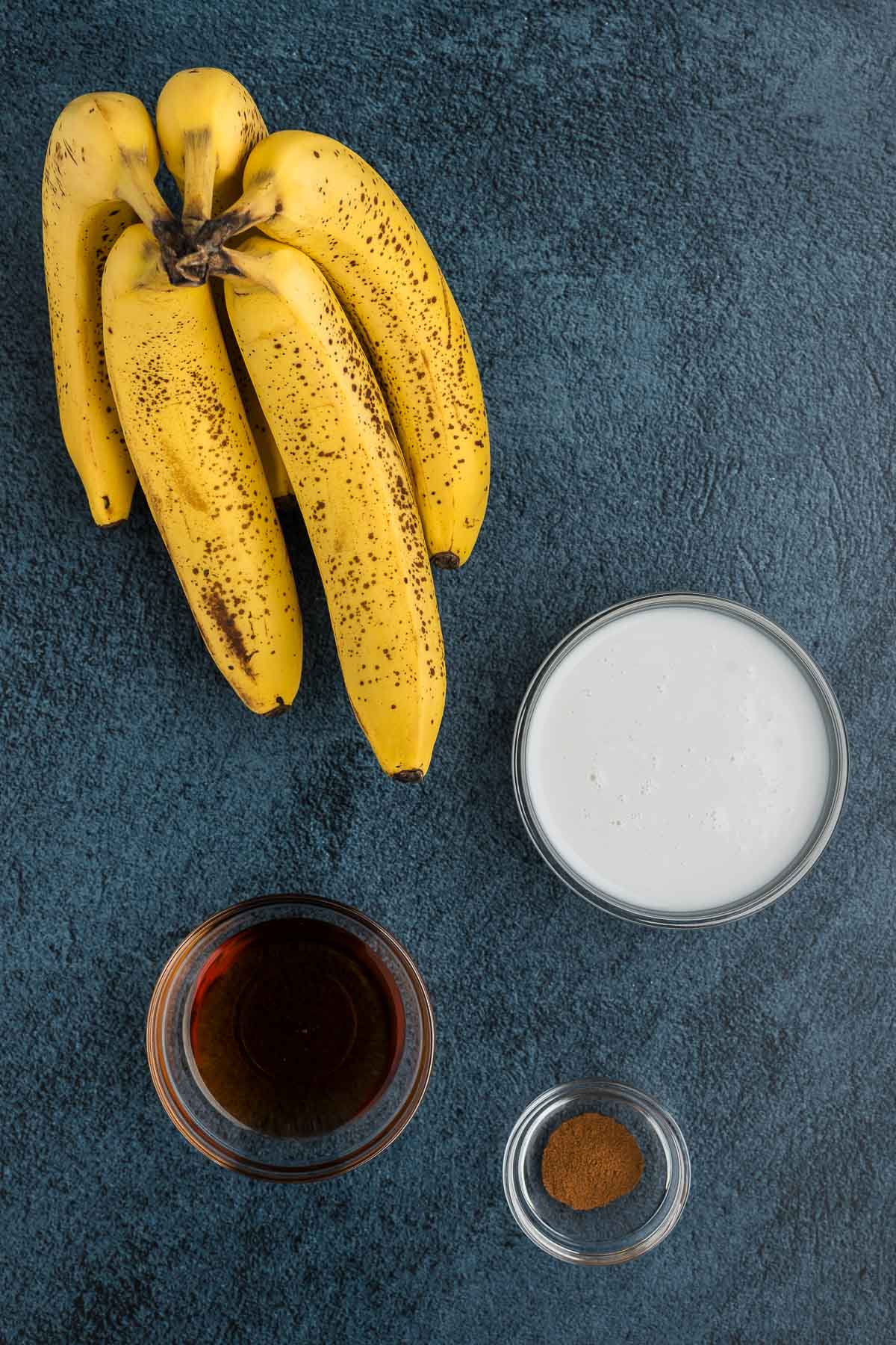 banana popsicle ingredients including banana, coconut milk, maple syrup and cinnamon